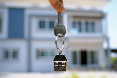 house keys with house in the background 