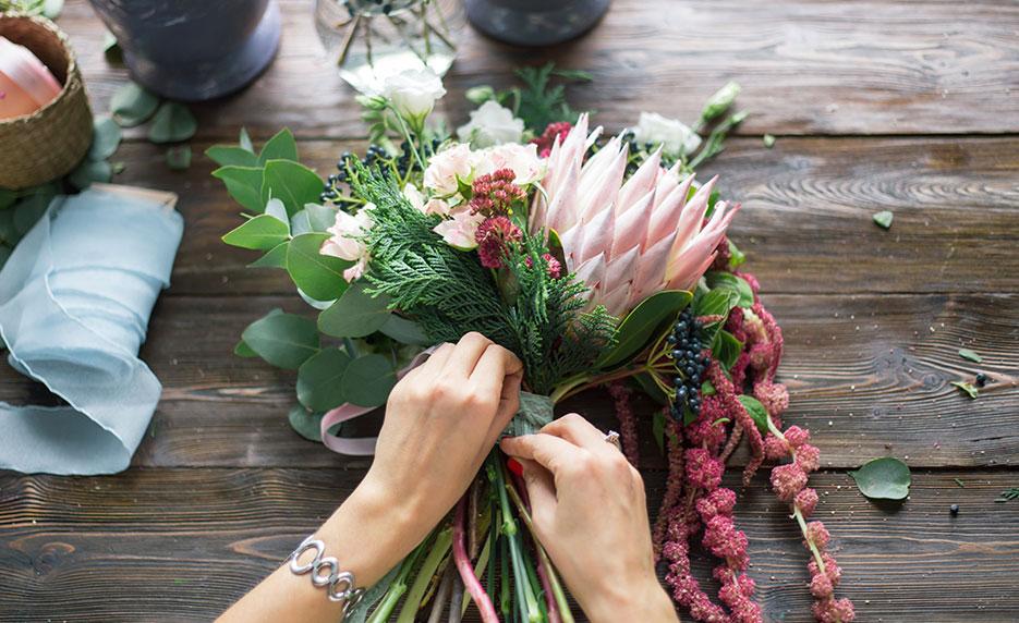 someone making a flower bouquet